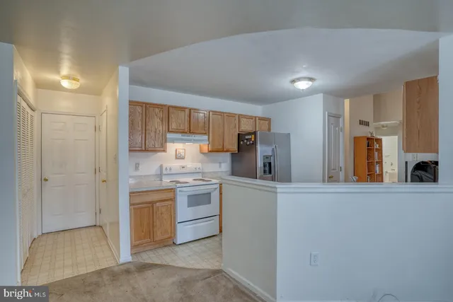 a kitchen with stainless steel appliances a refrigerator and a stove top oven