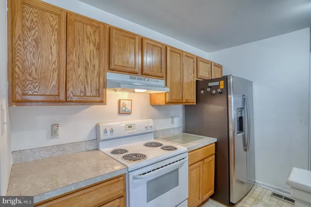 a kitchen with a stove and a refrigerator