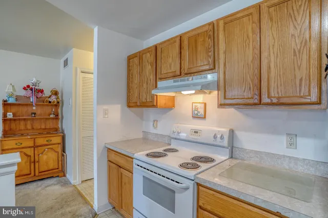 a kitchen with stainless steel appliances granite countertop a stove and a refrigerator