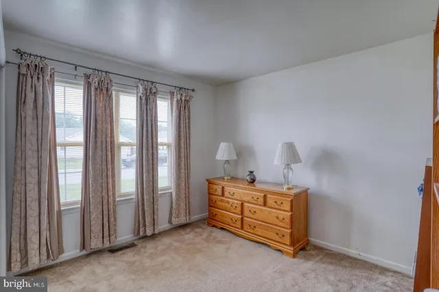 a bedroom with bed and window