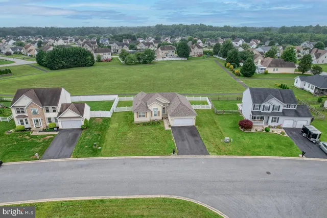 an aerial view of a house with big yard