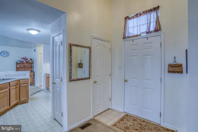 a view of a hallway to closet and cabinet