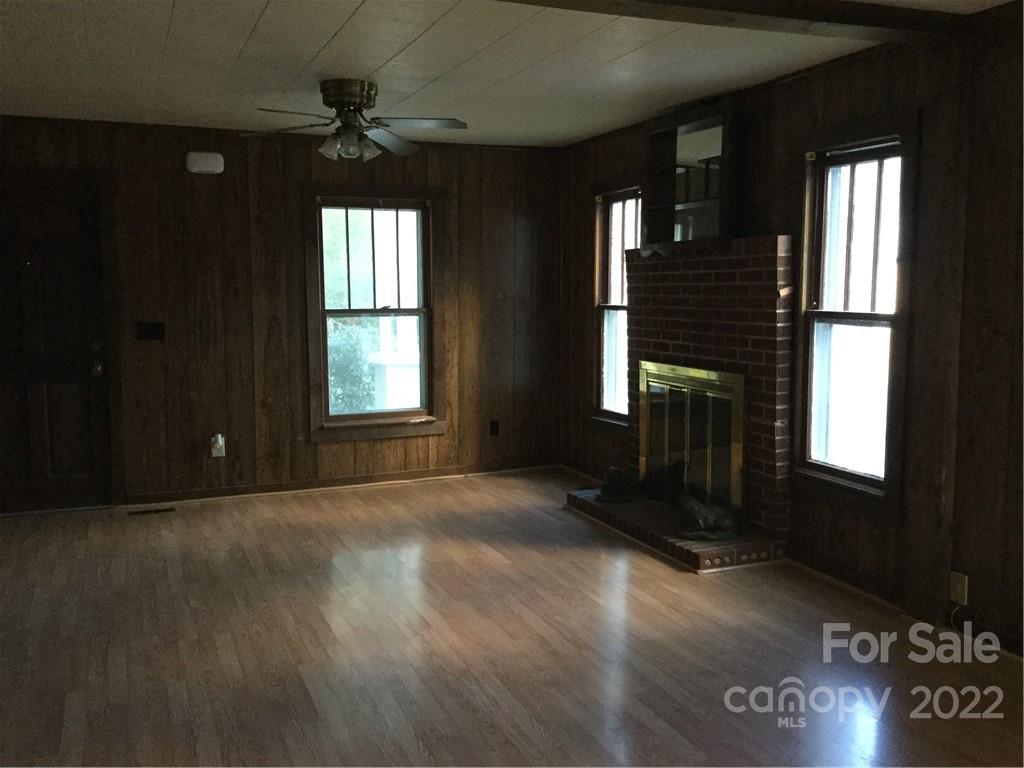 125 John Smith Road Rutherfordton, NC 28139 - Photo 8 of 13 a view of an empty room with a fireplace and a window