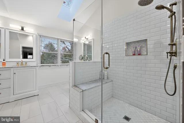 a bathroom with a sink a mirror and a shower