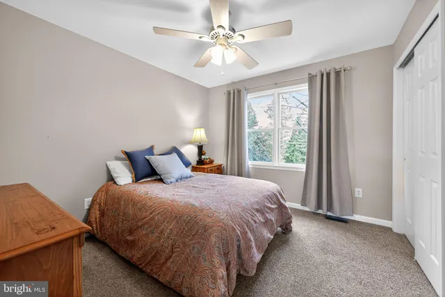 a bed sitting in a bedroom next to a window