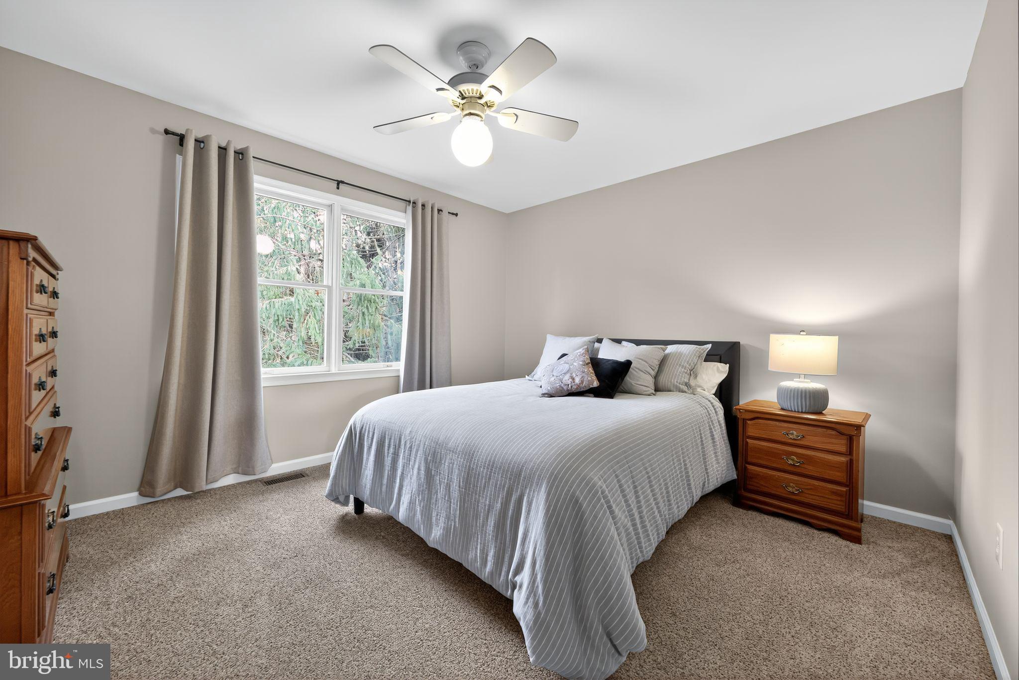 39 Bramley Road Moorestown, NJ 08057 - Photo 19 of 28 a bedroom with a bed and a chandelier