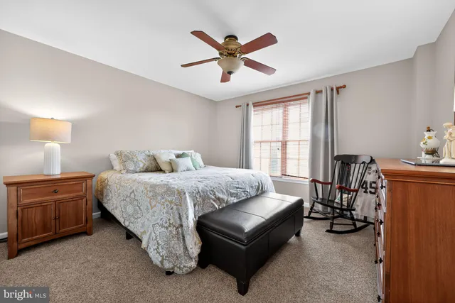 a spacious bedroom with a bed and window