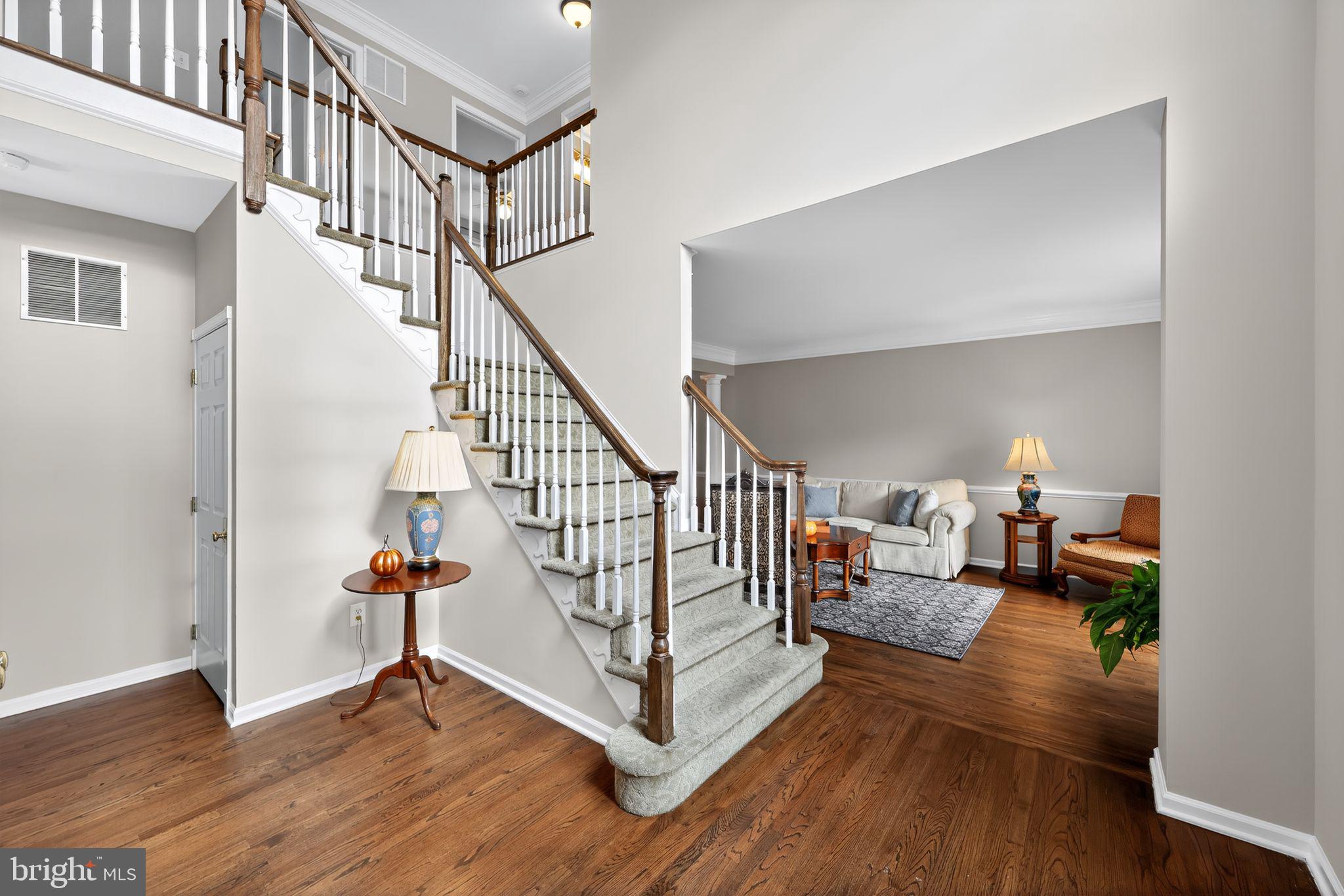 39 Bramley Road Moorestown, NJ 08057 - Photo 2 of 28 a view of a livingroom with wooden floor and stairs
