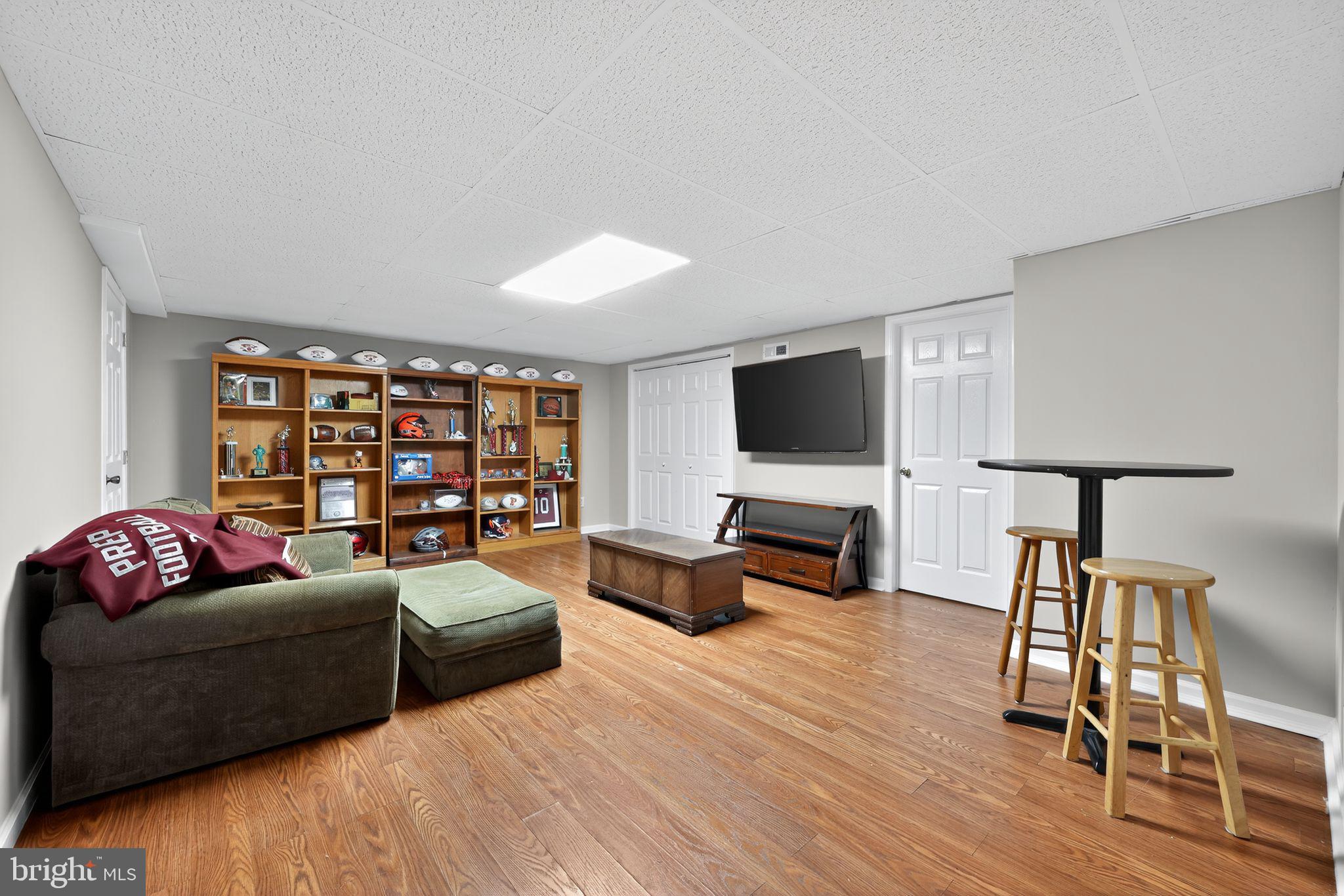 39 Bramley Road Moorestown, NJ 08057 - Photo 23 of 28 a living room with furniture flat screen tv and wooden floor
