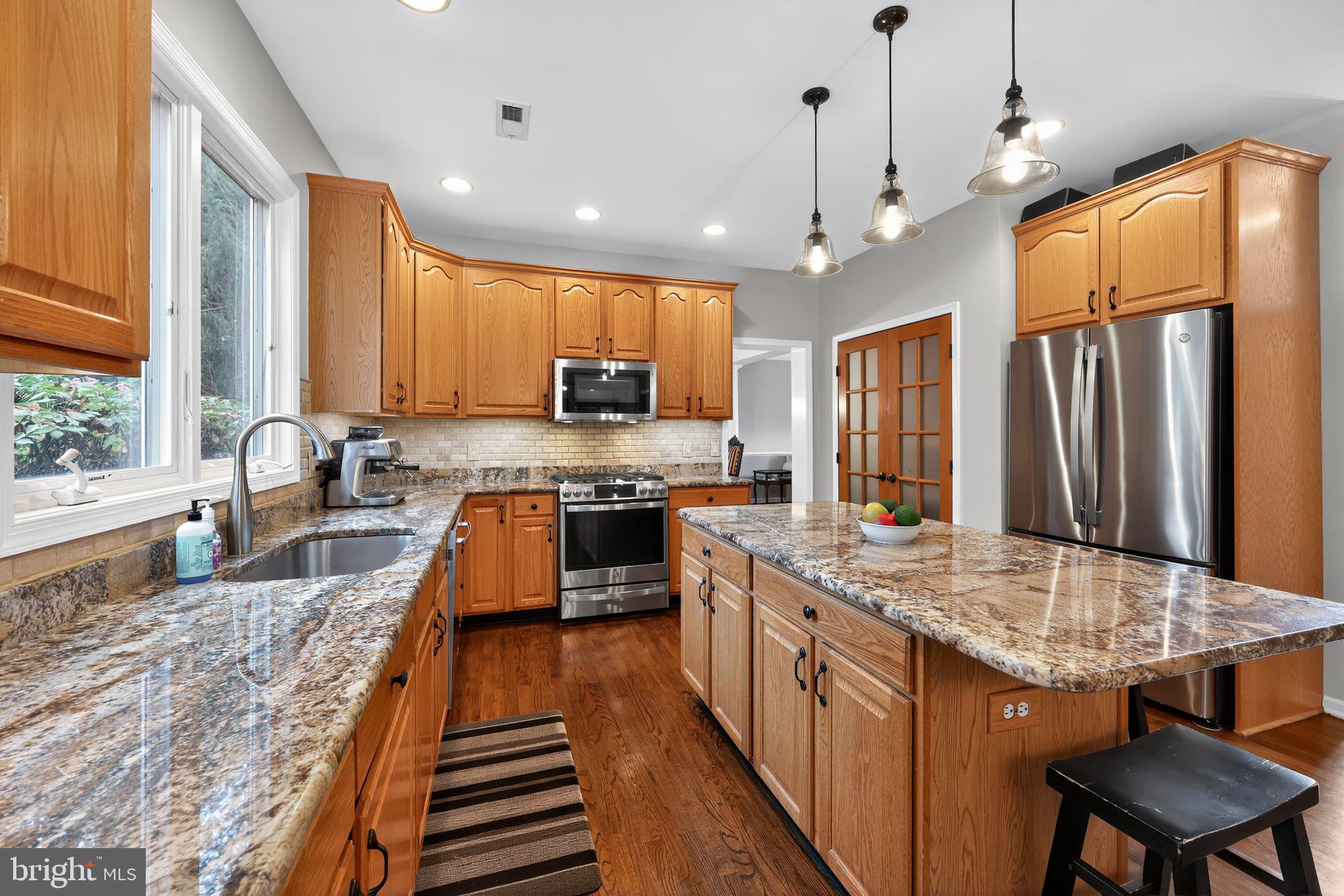 39 Bramley Road Moorestown, NJ 08057 - Photo 7 of 28 a large kitchen with kitchen island a large counter space a sink appliances and cabinets
