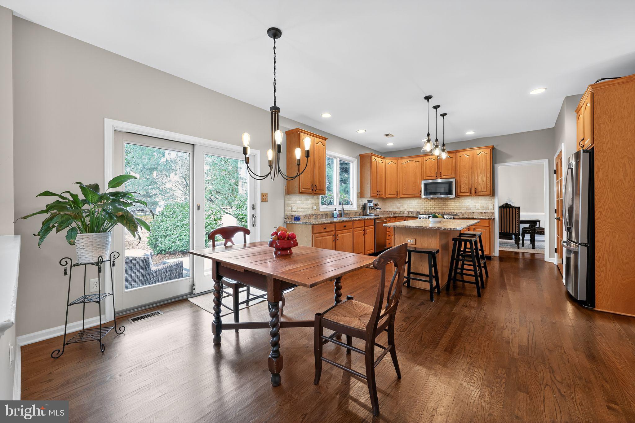 39 Bramley Road Moorestown, NJ 08057 - Photo 8 of 28 a view of a dining room and livingroom with furniture wooden floor a chandelier