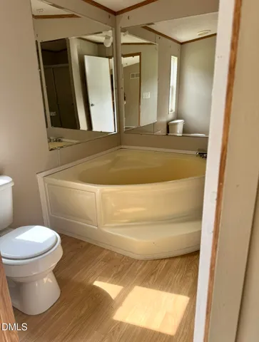 a bathroom with a toilet and a mirror