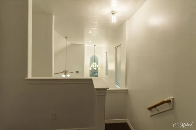 an empty room with wooden floor and a window
