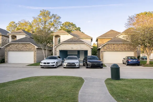 a couple of cars parked in front of a house