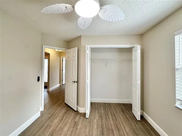 a view of a room with wooden floor