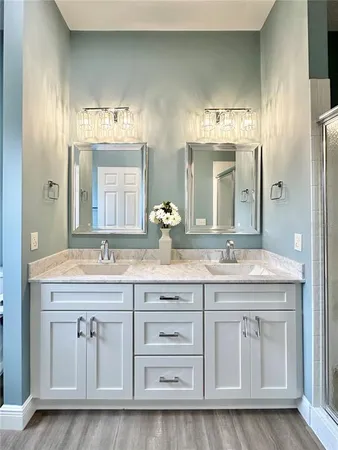 a bathroom with double sink and a mirror