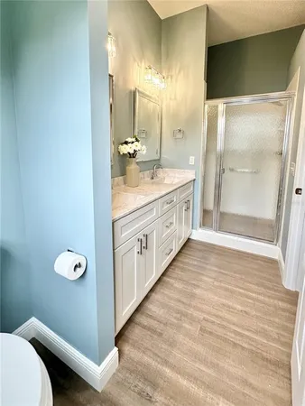 a bathroom with a double vanity sink and a mirror