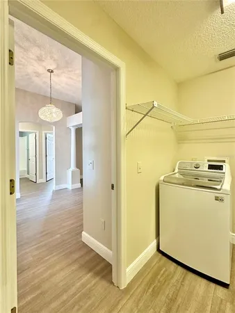 a view of a room with wooden floor and cabinet