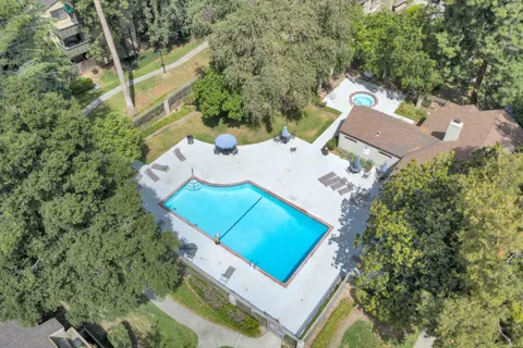 an aerial view of a house with a yard and trees