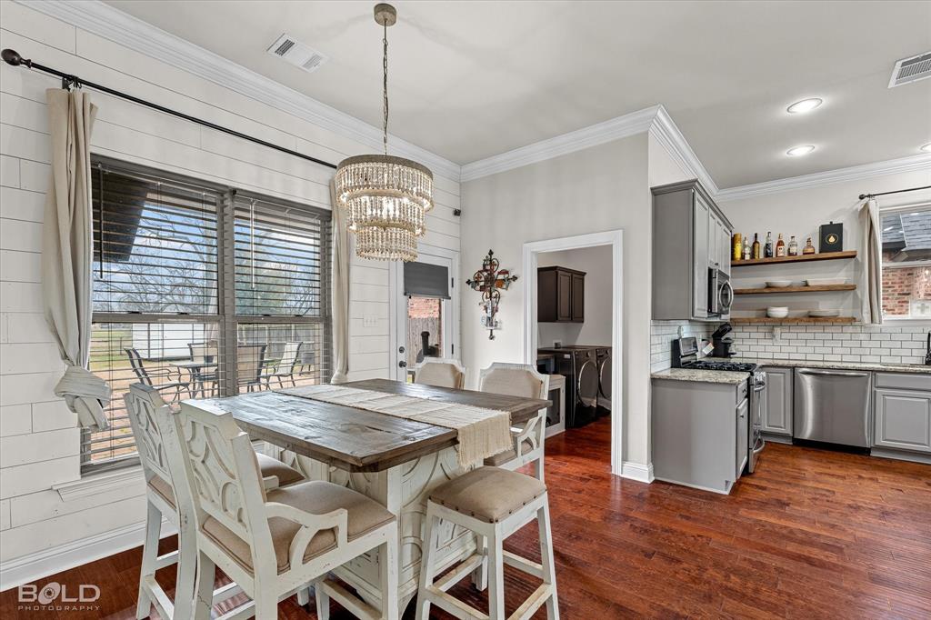 946 Maize Street Bossier City, LA 71111 - Photo 26 of 39 a view of a dining room with furniture window and wooden floor