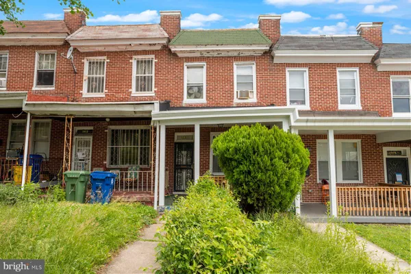 front view of a brick house with a large window