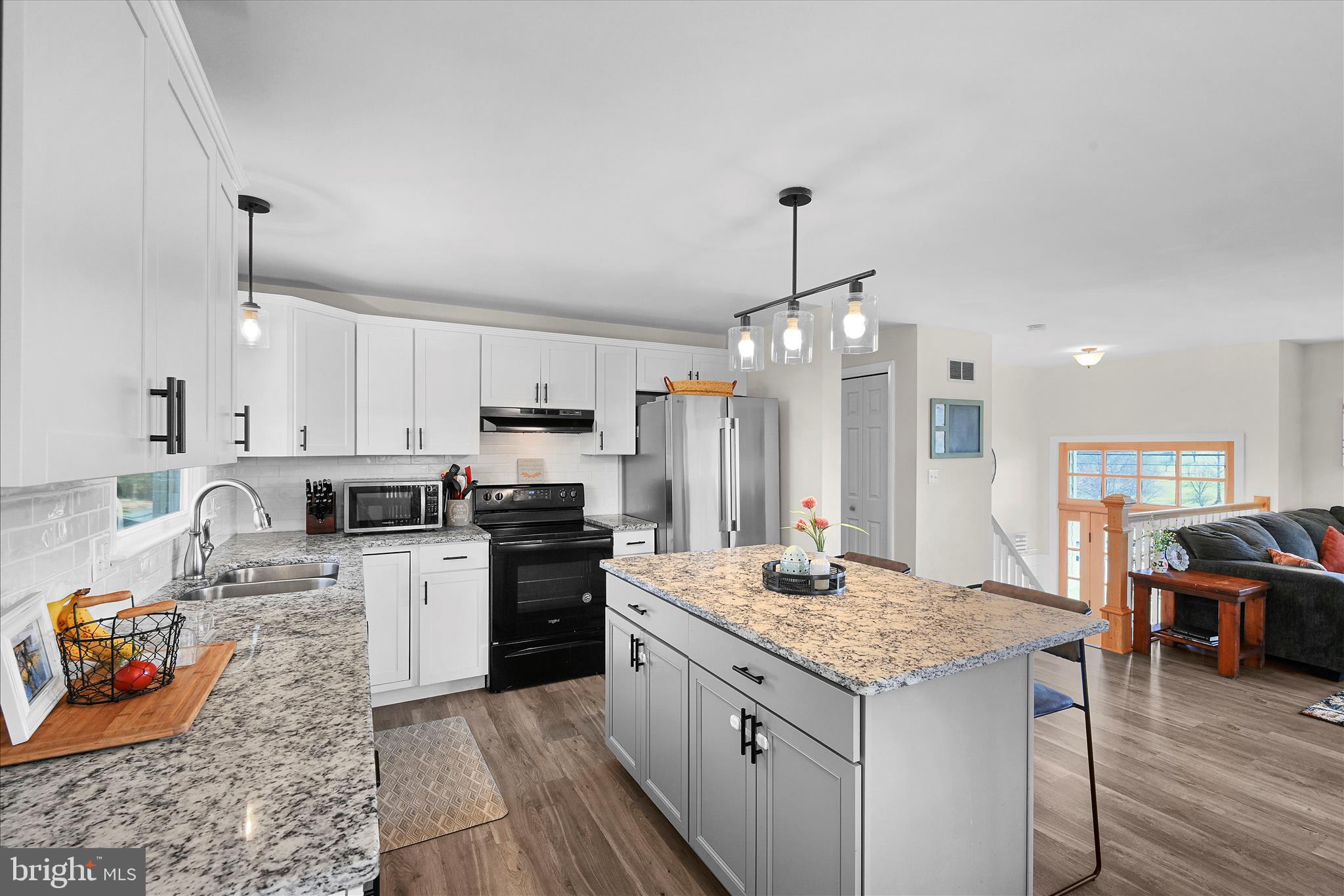 668 Scotland Road Quarryville, PA 17566 - Photo 13 of 41 a kitchen with stainless steel appliances granite countertop a sink stove and refrigerator