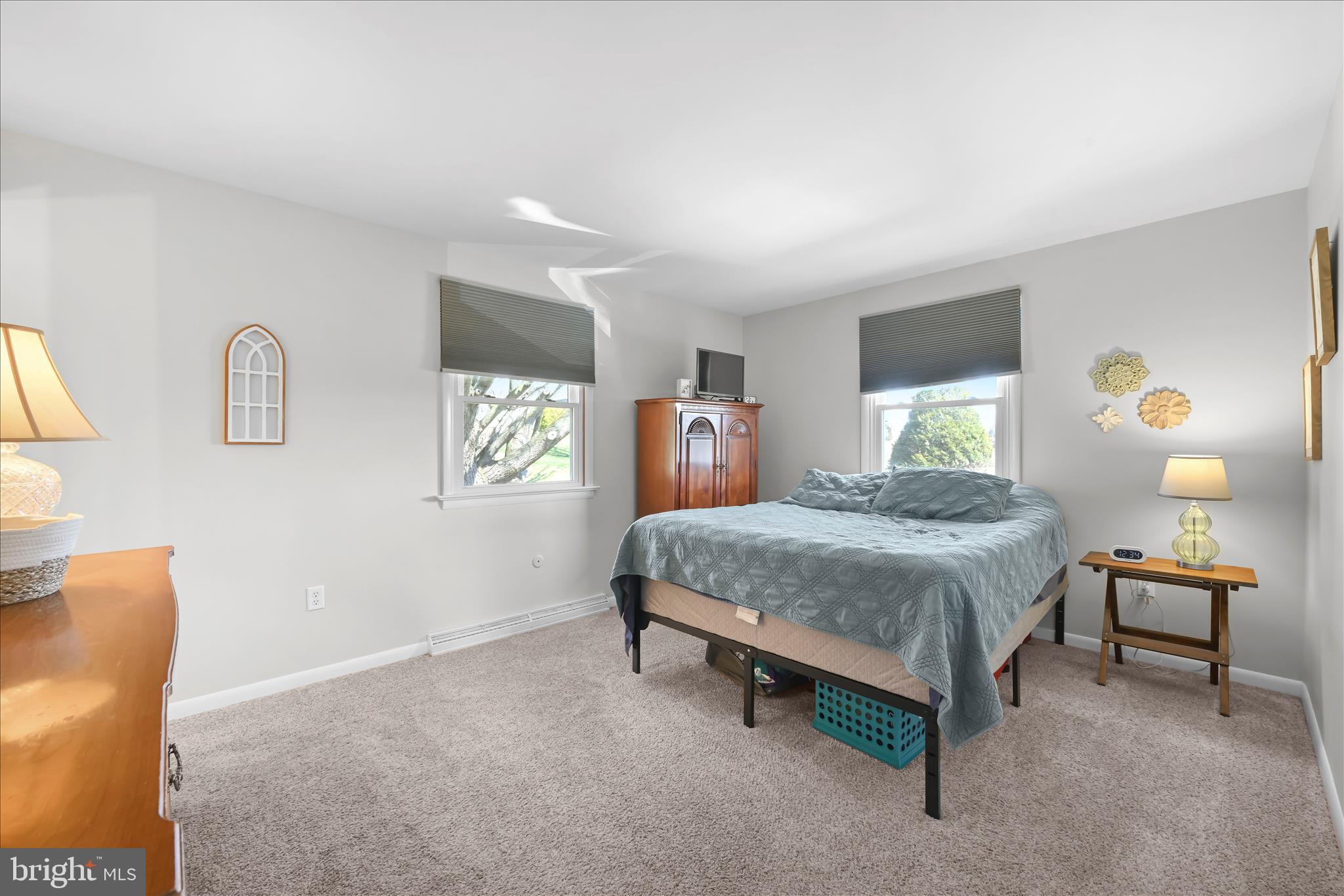 668 Scotland Road Quarryville, PA 17566 - Photo 17 of 41 a bedroom with a bed and lamp