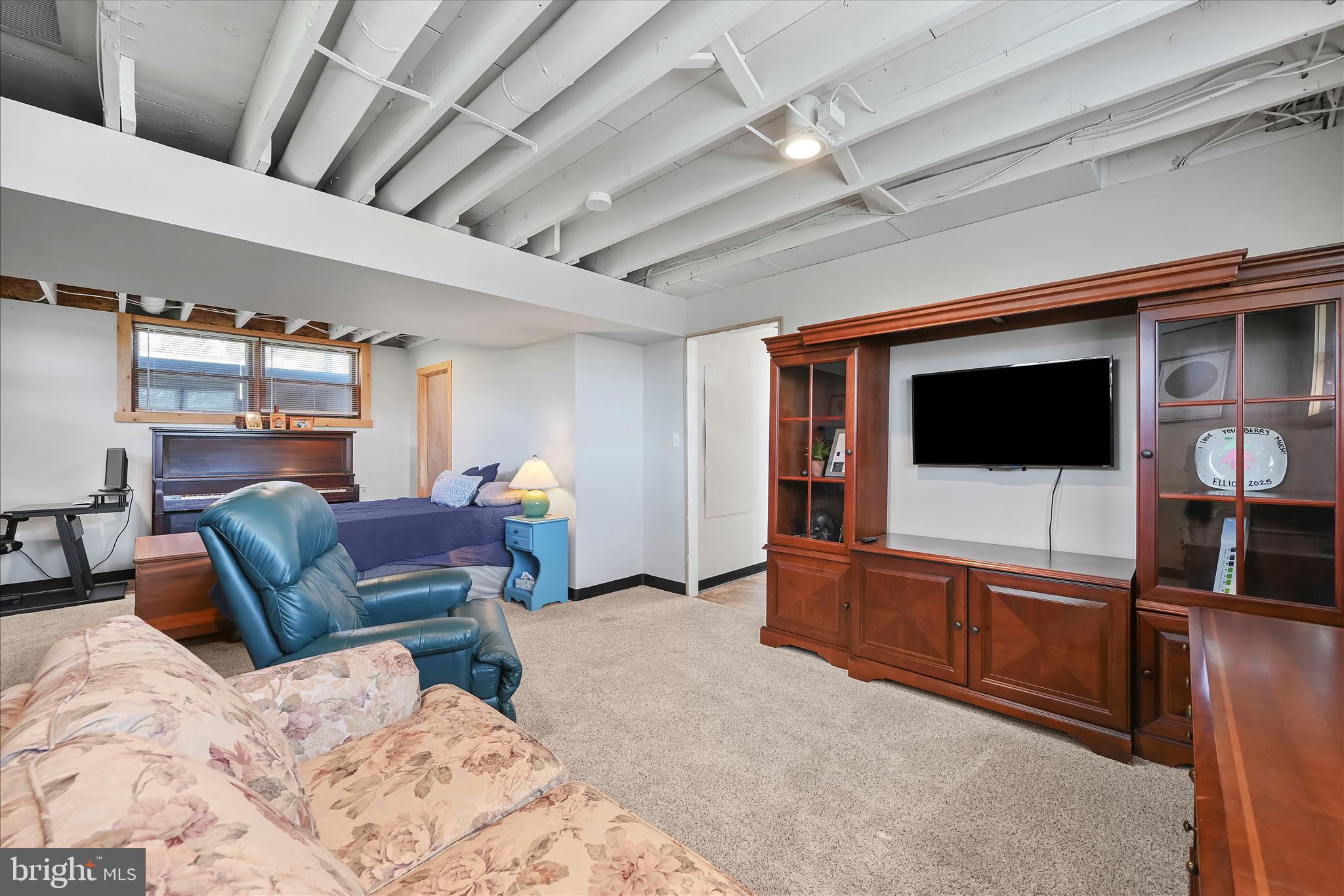 668 Scotland Road Quarryville, PA 17566 - Photo 27 of 41 a living room with furniture a flat screen tv and a walk in closet
