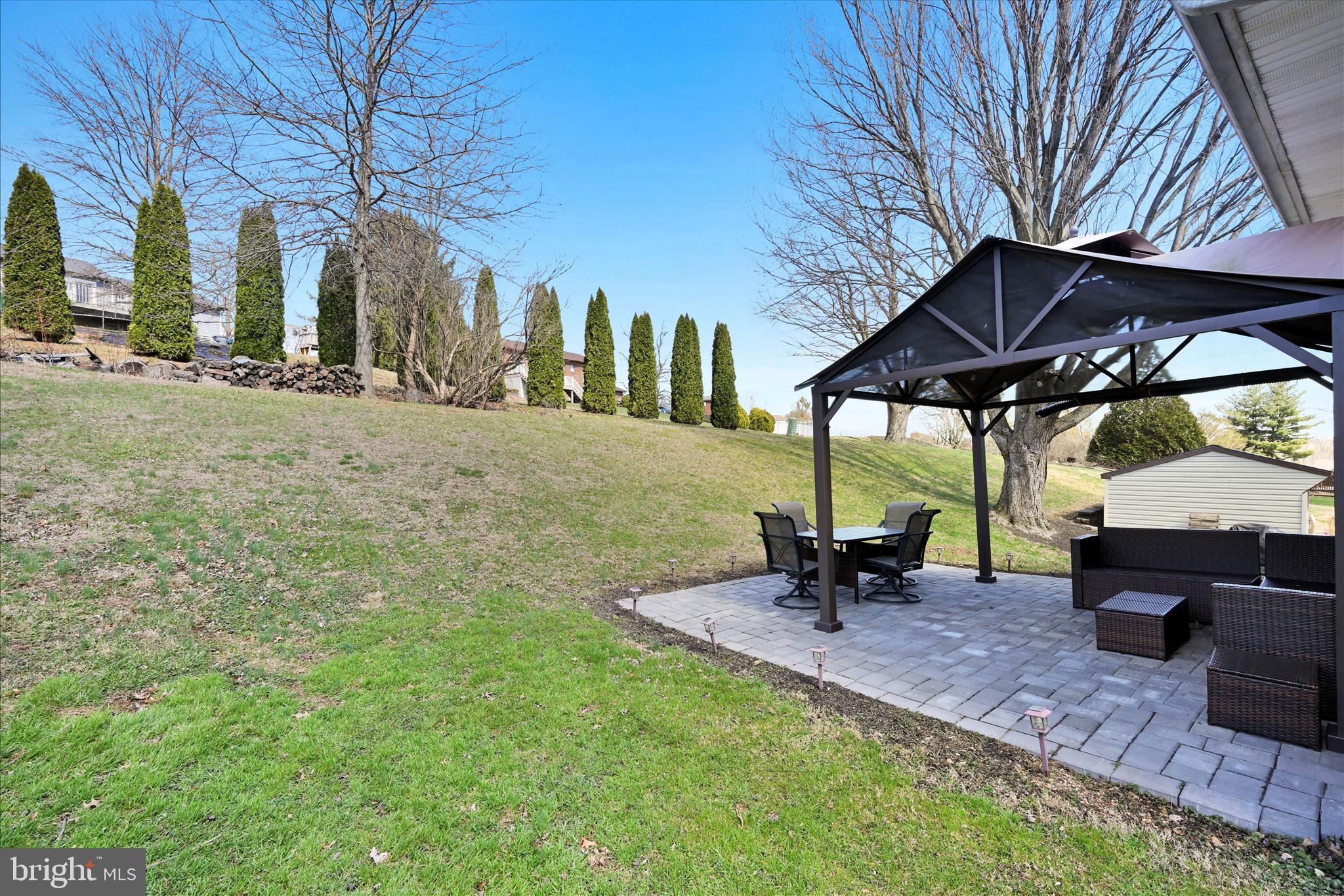 668 Scotland Road Quarryville, PA 17566 - Photo 29 of 41 a view of a patio with a table and chairs under an umbrella