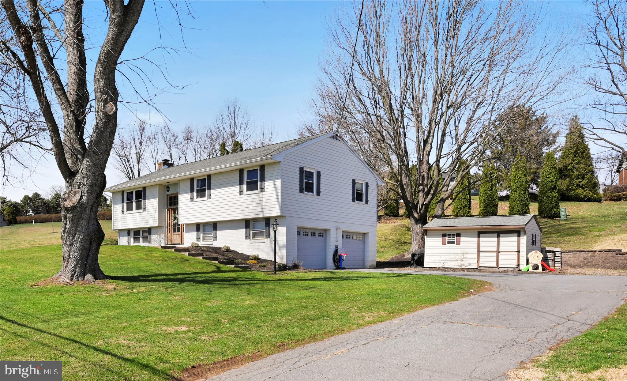 668 Scotland Road Quarryville, PA 17566 - Photo 5 of 41 a front view of a house with a garden and trees