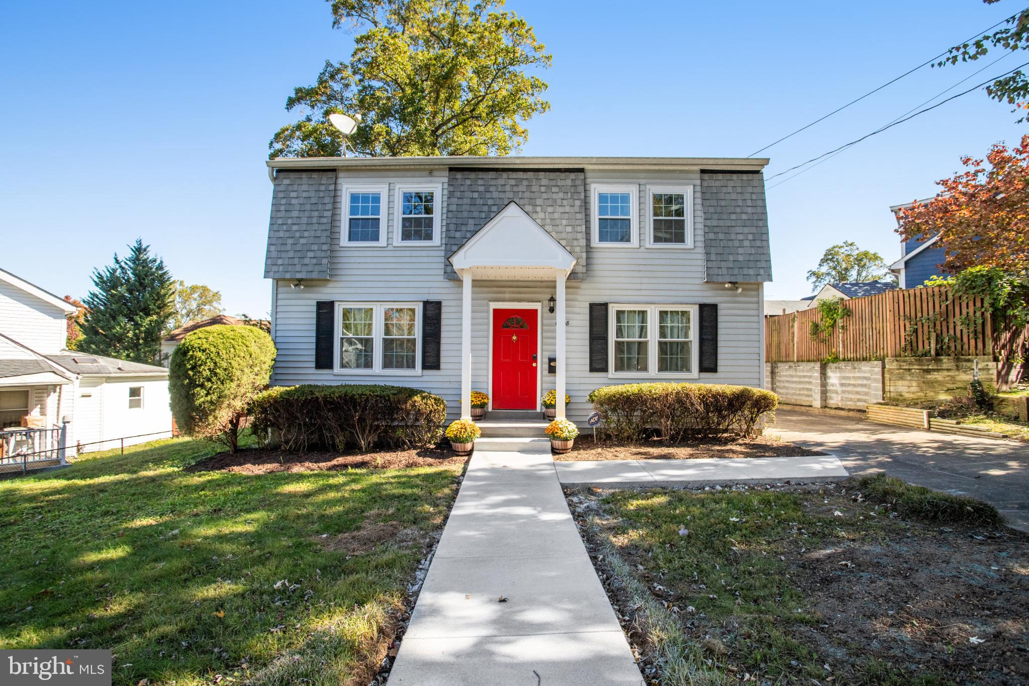 Charming home with vibrant red door.