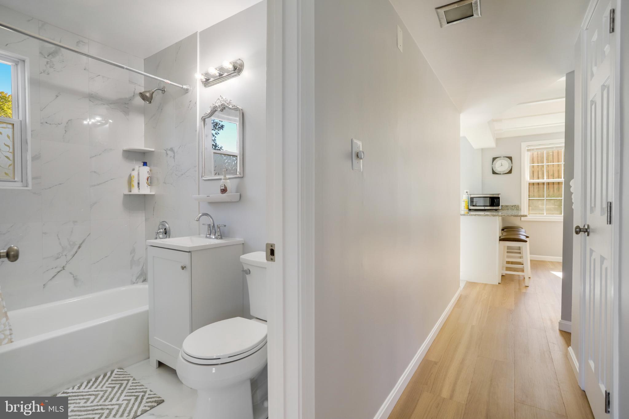 6908 Barrett Road Falls Church, VA 22042 - Photo 36 of 44 Modern bathroom meets inviting hallway.