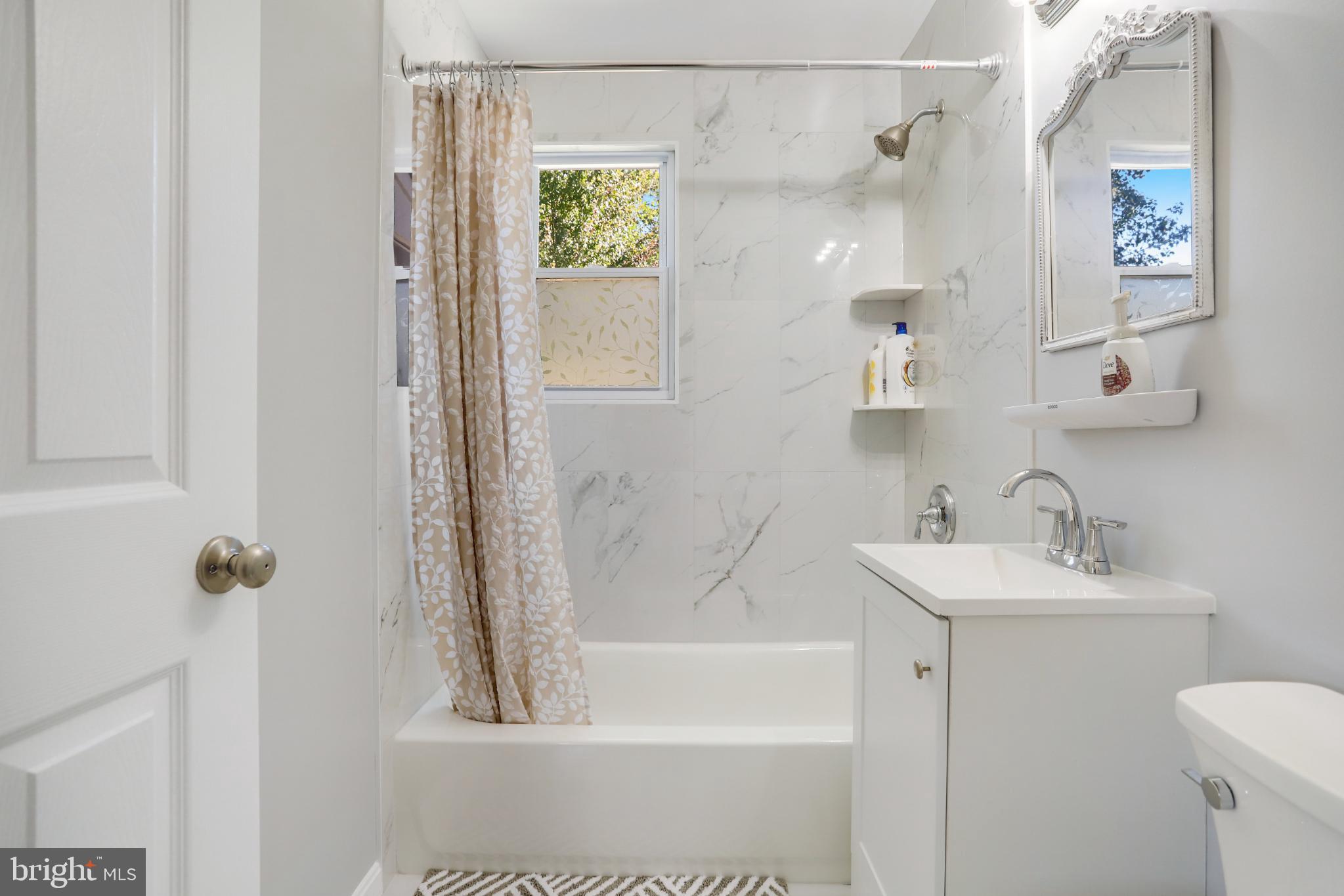 6908 Barrett Road Falls Church, VA 22042 - Photo 37 of 44 Modern bathroom with elegant marble accents.
