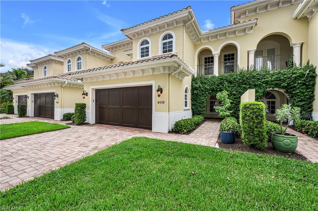 a front view of a house with a garden and plants