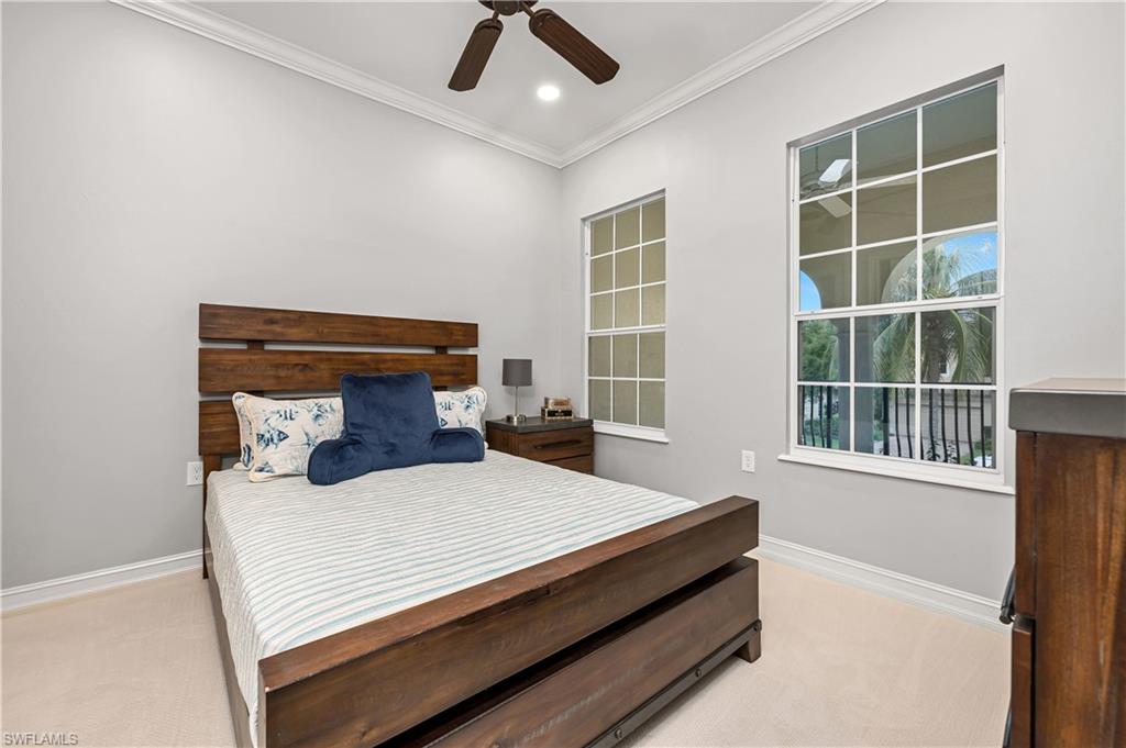 4819 West Blvd Court, Unit 103 Naples, FL 34103 - Photo 11 of 19 a bedroom with a bed and a window