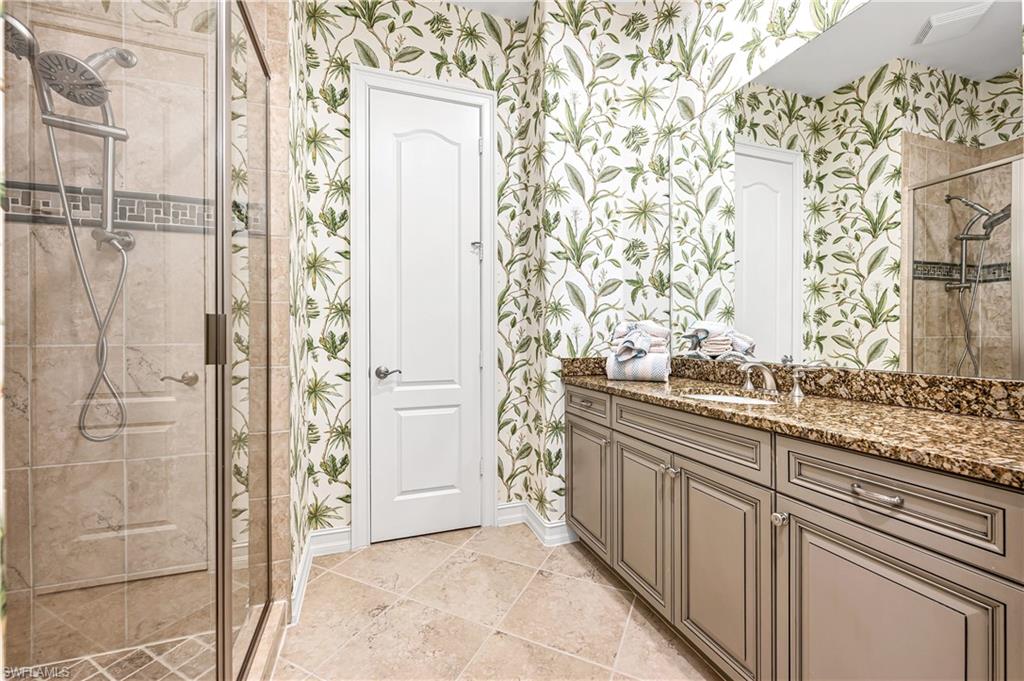 4819 West Blvd Court, Unit 103 Naples, FL 34103 - Photo 13 of 19 a bathroom with a granite countertop shower and a sink