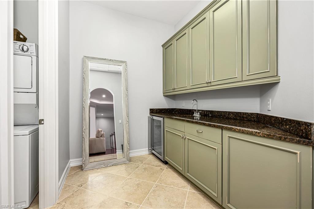 4819 West Blvd Court, Unit 103 Naples, FL 34103 - Photo 15 of 19 a kitchen with granite countertop cabinets and sink