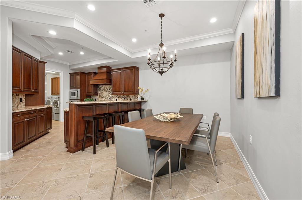 4819 West Blvd Court, Unit 103 Naples, FL 34103 - Photo 5 of 19 a view of a dining room with furniture