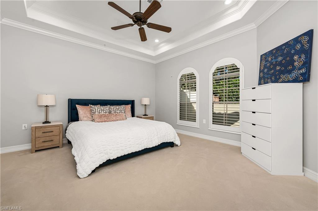 4819 West Blvd Court, Unit 103 Naples, FL 34103 - Photo 7 of 19 a bedroom with a bed and a dresser