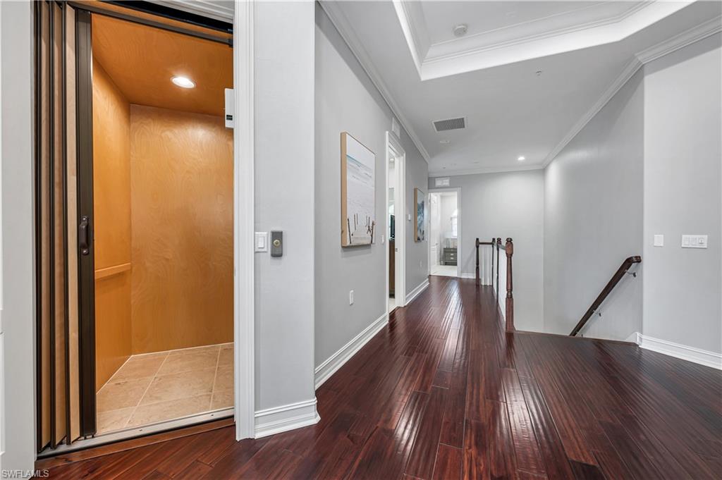 4819 West Blvd Court, Unit 103 Naples, FL 34103 - Photo 9 of 19 a view of a hallway with wooden floor