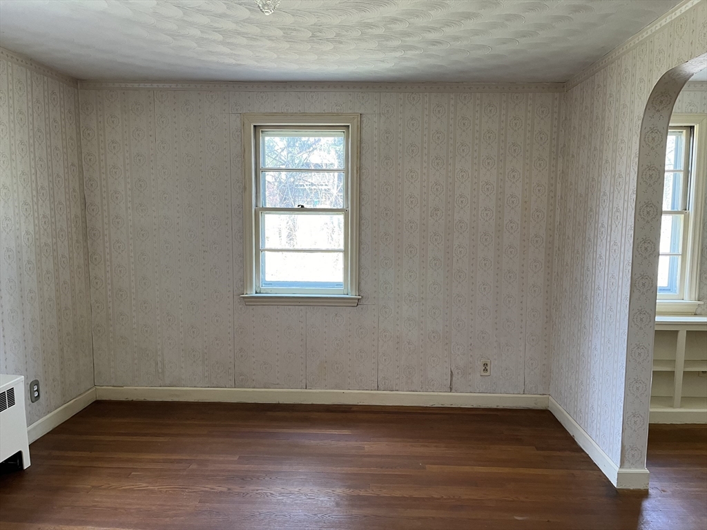 10 Renfrew Street Worcester, MA 01604 - Photo 3 of 25 an empty room with wooden floor and windows