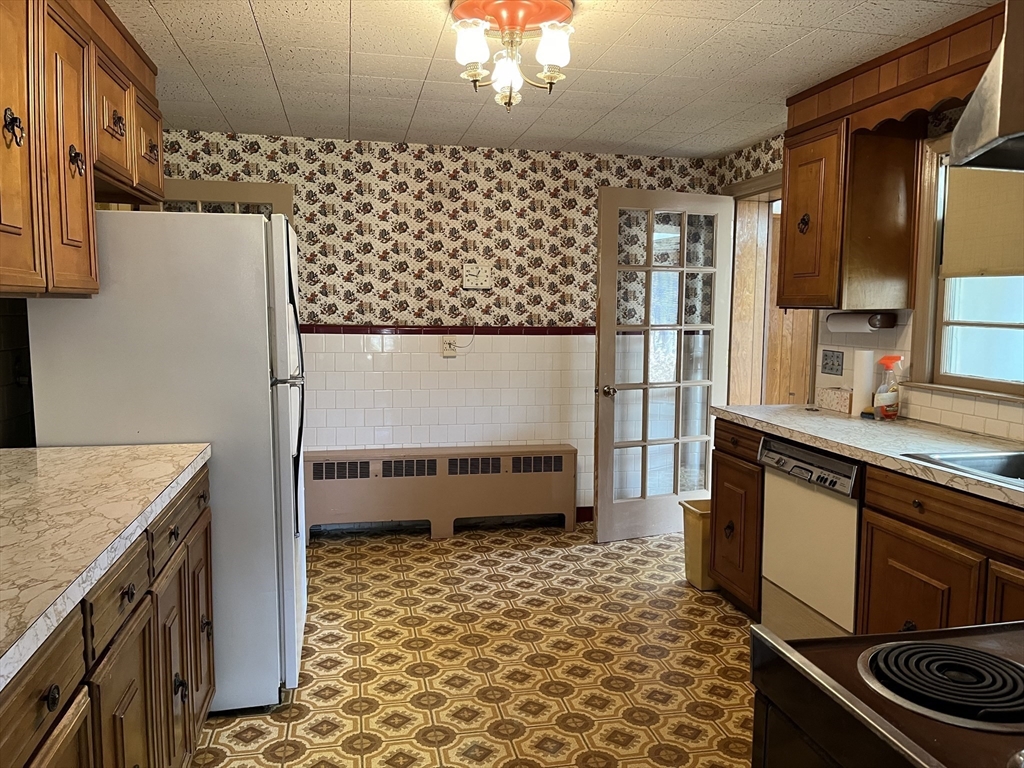 10 Renfrew Street Worcester, MA 01604 - Photo 4 of 25 a kitchen with a sink a stove and a refrigerator
