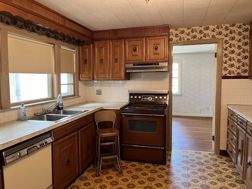 10 Renfrew Street Worcester, MA 01604 - Photo 5 of 25 a kitchen with stainless steel appliances granite countertop a stove a sink and a microwave