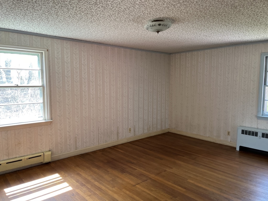 10 Renfrew Street Worcester, MA 01604 - Photo 8 of 25 a view of an empty room with wooden floor and a window