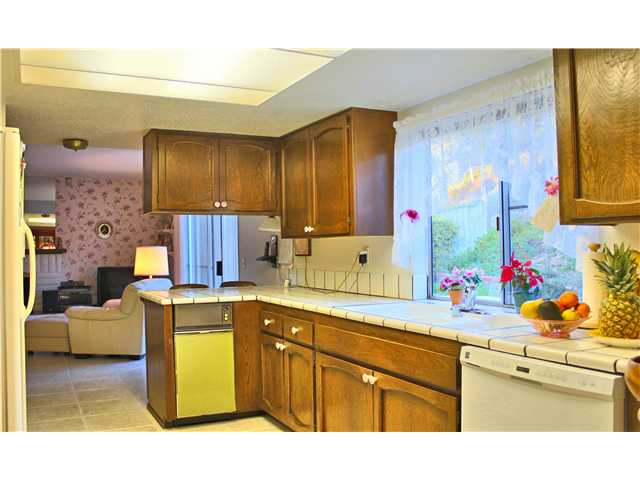 2426 Windmill View Road El Cajon, CA 92020 - Photo 6 of 23 Tile kitchen centered between the family room and dining.