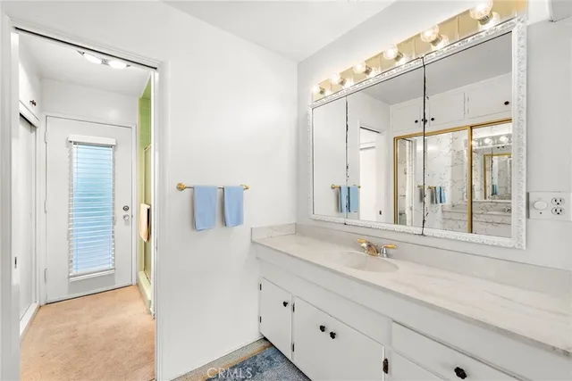 a bathroom with a granite countertop sink mirror and vanity