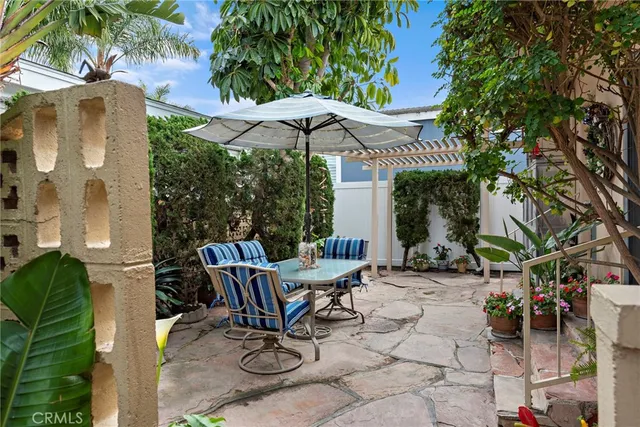a view of a chair and table in backyard