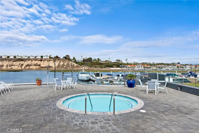 a view of a swimming pool with a lawn chairs under an umbrella