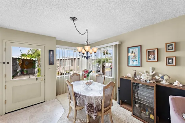 a view of a dining room with furniture and chandelier