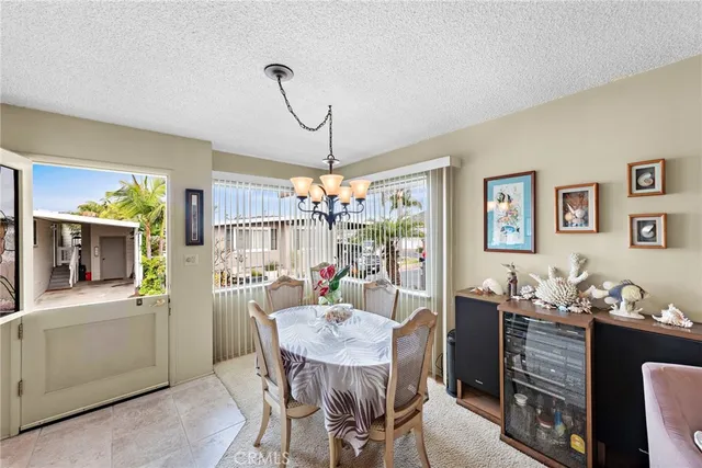 a view of a dining room with furniture and chandelier